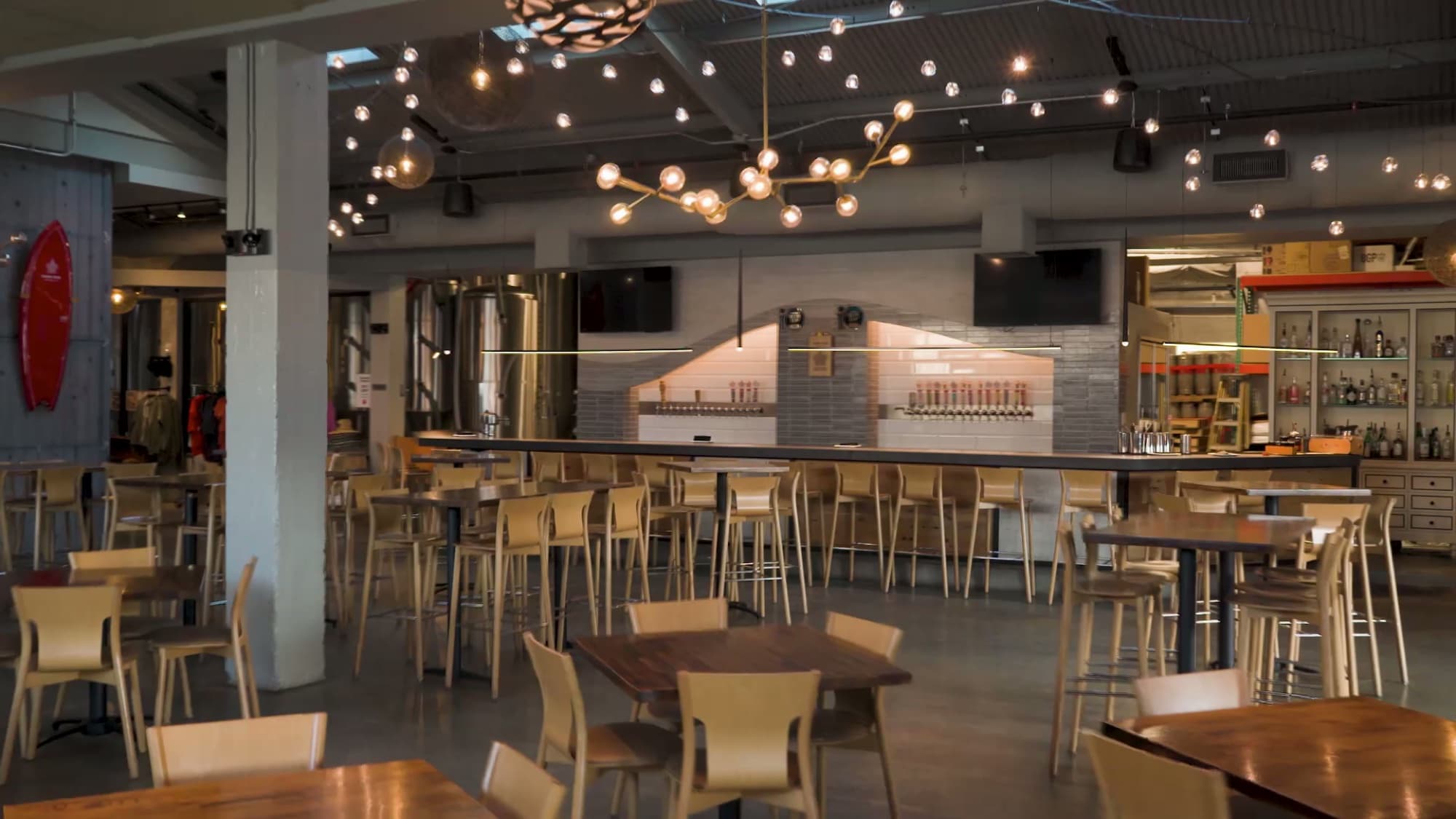 Hana Koa Brewing Co. — taproom bar tables chandelier