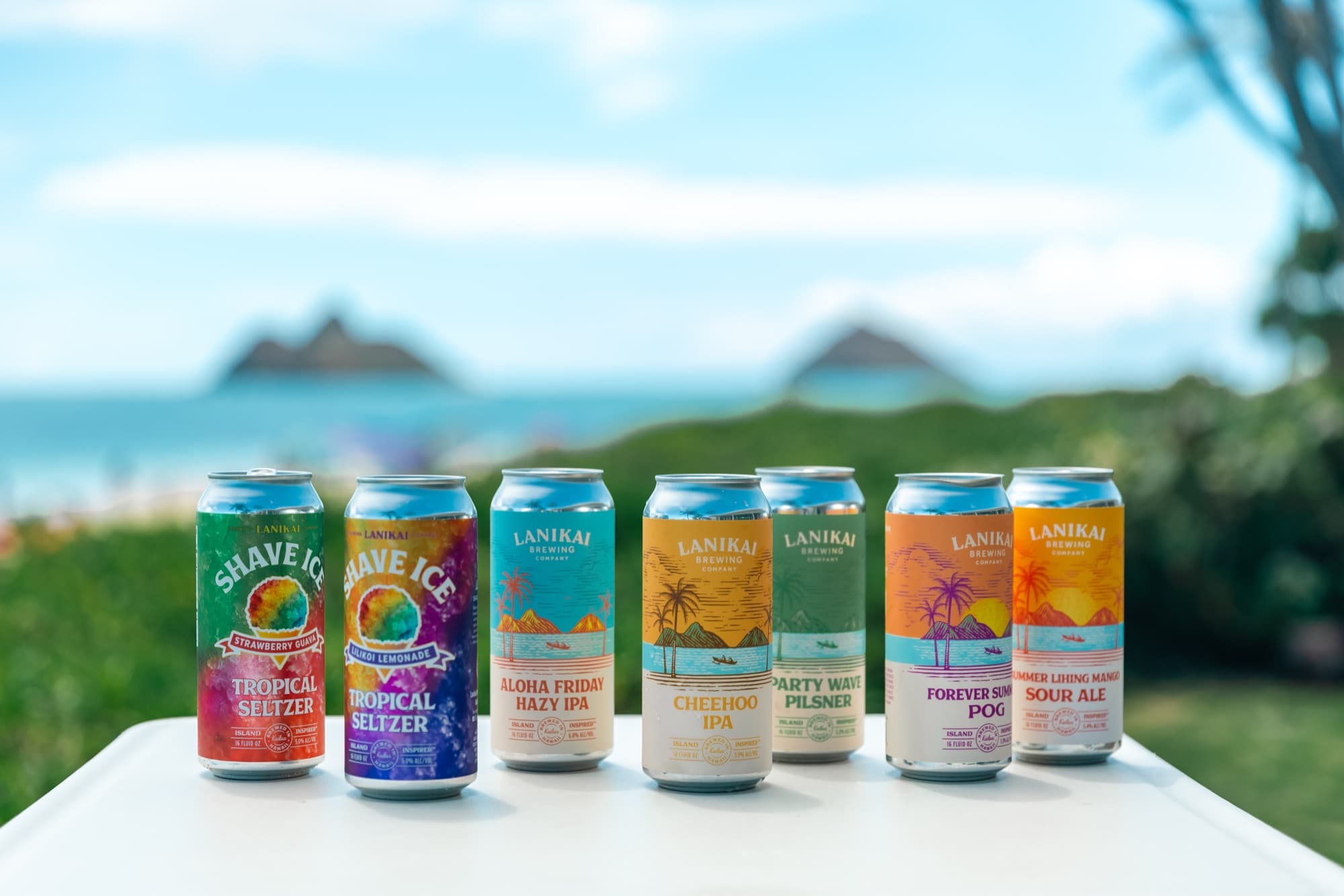 Lanikai Brewing — Volcano — beer can lineup beach