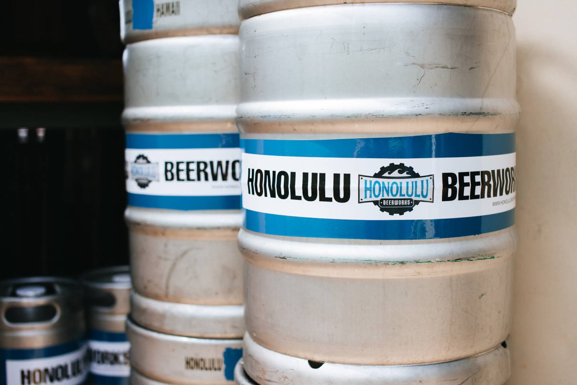 Honolulu Beerworks — stacked branded kegs closeup
