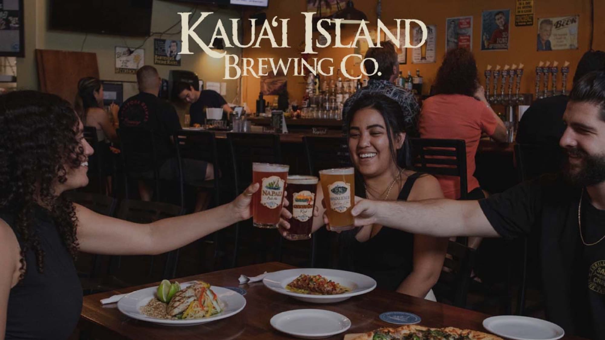 Kauai Island Brewing Company — friends cheers beers taproom table