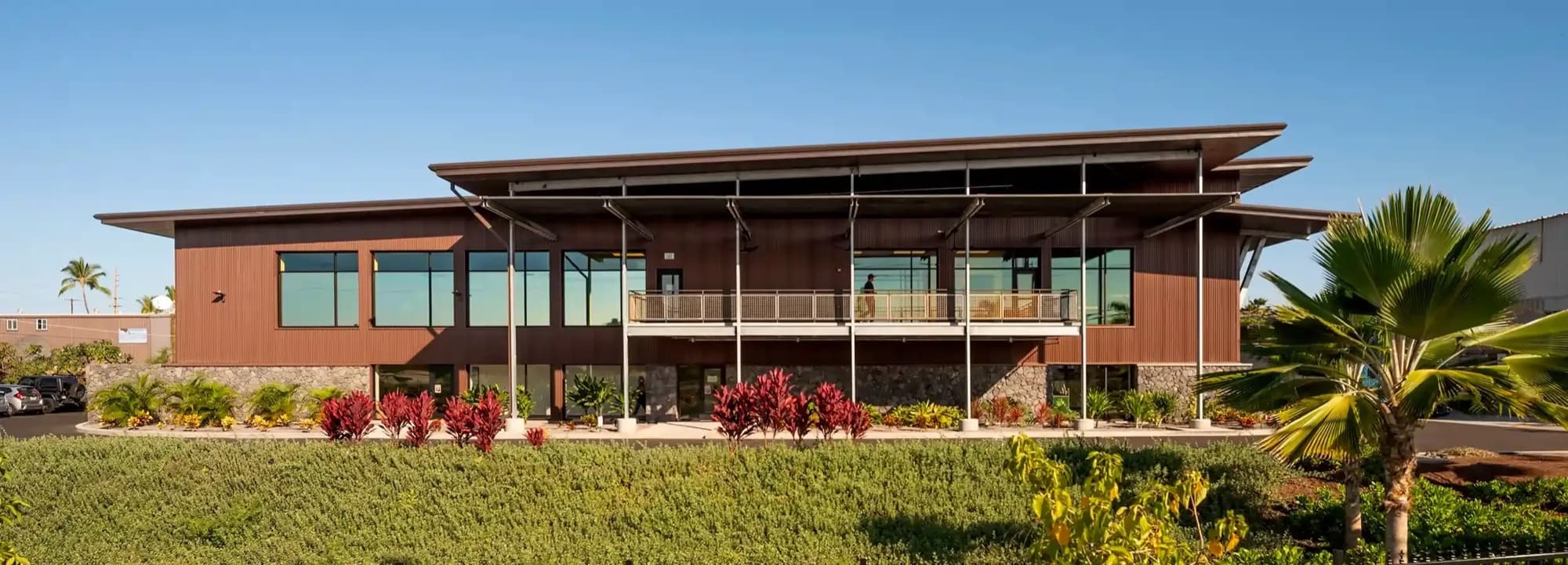 Kona Brewery — two story building tropical landscaping